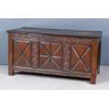 A Late 17th Century Panelled Oak Coffer, with moulded edge to top, frieze carved with scroll work,