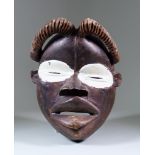 A Dan Mask, Ivory Coast, Second Half of 20th Century, with carved headpiece and white painted