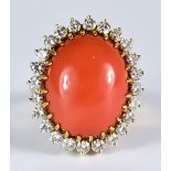 A Cabochon Coral and Diamond Ring, Modern, 18ct gold set with a centre cabochon coral stone, 16mm