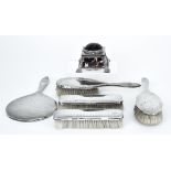 A George V Silver Mounted and Tortoiseshell Inkwell and a Five-Piece Silver Backed Dressing Table
