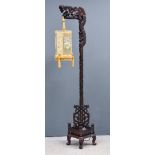 A Chinese Hardwood Standard Lamp, the whole boldly carved in the form of a dragon, supporting a