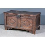 A Late 17th Century Panelled Oak Coffer, with moulded edge to top and fluted frieze, two panels to