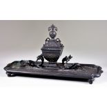 A Brown Patinated Bronze Desk Inkwell, Late 19th/20th Century, cast with dragon supports, and raised