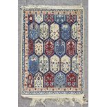 A 20th Century Bakhtiari Rug, woven in pastel colours with a central trellis design filled with leaf