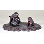 A Japanese Bronze Okimono, of three Akita puppies, with engraved details to fur and silvered eyes,