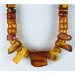 A Semi Worked Amber Necklace, fashioned from discs and abstract shapes, 470mm in length, gross