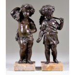 19th Century Continental School - Pair of brown patinated bronze standing figures of Putti