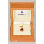 An 18ct Gold Enamelled Egg Pendant, Modern, by Faberge, 25mm x 10mm, red enamel finish decorated