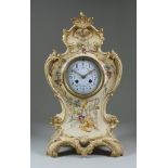 A 19th Century French Porcelain Cased Mantel Clock, the 4.25ins diameter dial with Arabic and
