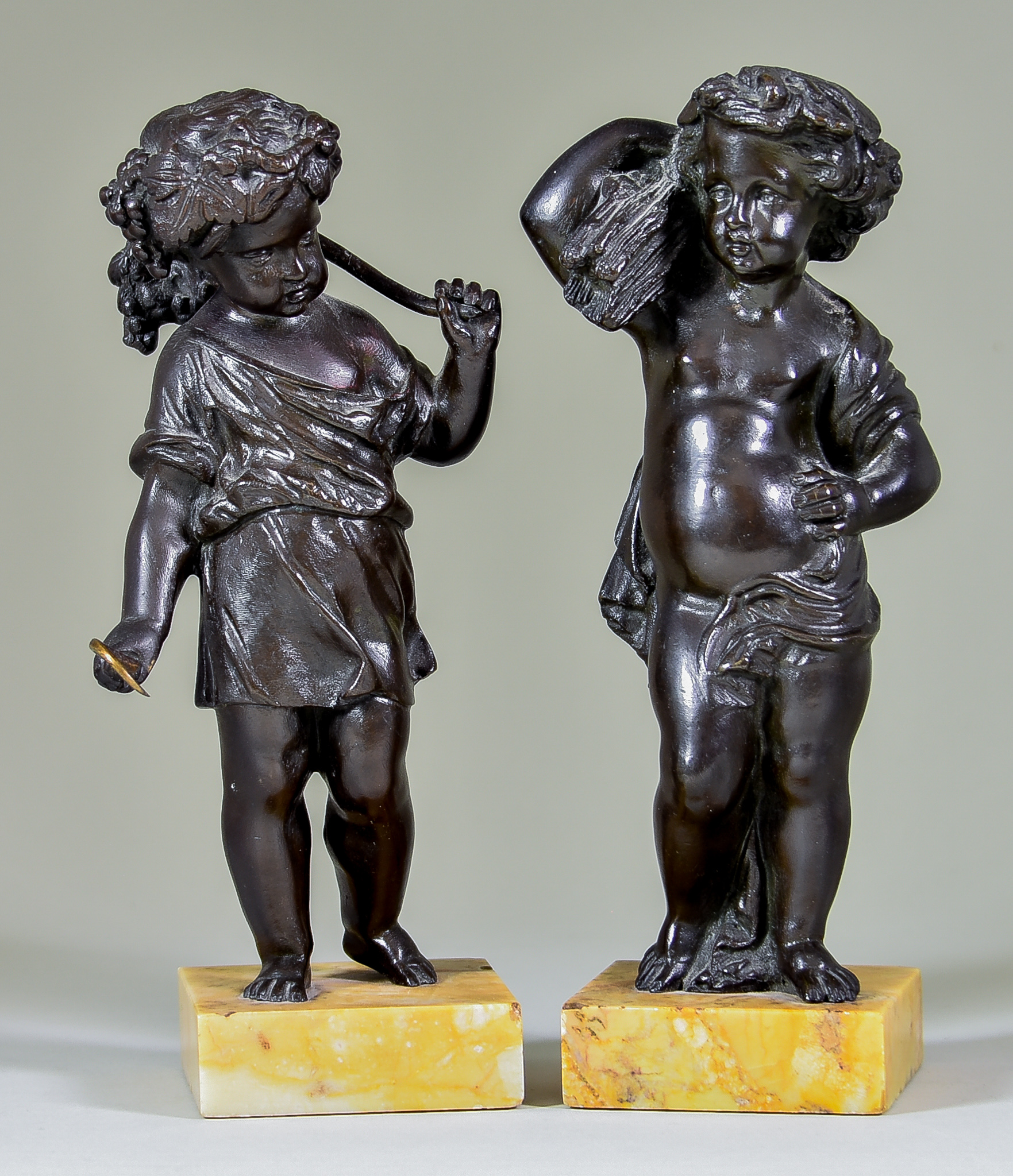 19th Century Continental School - Pair of brown patinated bronze standing figures of putti