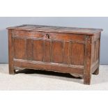 A Late 17th Century Panelled Oak Coffer, with four panels to lid and front, the whole with moulded