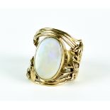 An Opal Ring, yellow metal, set with an opal stone, 19mm x 14mm,in a stylised art deco mount, size