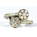A Diamond Cross Over Flower Head Ring, Modern, 18ct white gold set with small brilliant cut white