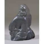 20th Century Canadian Innuit School - Carved soapstone - Eskimo in a seated position, 4.5ins high,