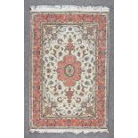 A 20th Century Part Silk Sarouk Rug, woven in pastel colours, with a central floral pole medallion