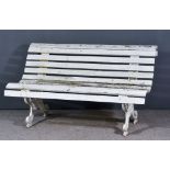 A 20th Century White Painted Cast Iron Slatted Garden Bench, fretted supports cast with fruiting