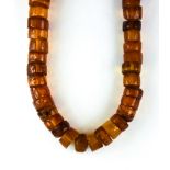 A String of Reconstituted Amber Beads, 20th Century, comprised of amber discs, approximately