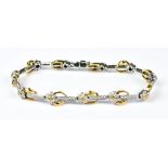 An 18ct Two Coloured Gold Diamond Set Bracelet, Modern, set with small diamonds in a floral motif,