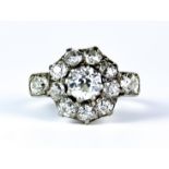 A Diamond Flower Head Ring, 20th Century 18ct gold set with a centre old European cut diamond,