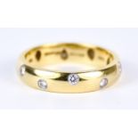 An 18ct Gold Wedding Band, Modern, by Tiffany & Co., set with small diamonds, size K+, gross