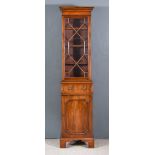 A Small Mahogany Bookcase of Georgian Design, the upper part with moulded cornice, fitted two