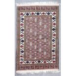 A Late 20th Century Persian Rug of Kazak Design, woven in colours of ivory, navy blue and fawn,