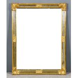 A Modern Gilt Framed Rectangular Wall Mirror, with scroll mouldings and inset with bevelled mirror