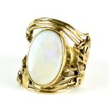 An Opal Ring, yellow metal, set with an opal stone, 19mm x 14mm, in a stylised art deco mount,