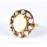 An Opal and Seed Pearl Ring, 20th Century, 9ct gold, set with a centre opal, 22mm x 10mm ,