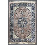 A Rug of Kashan Design, woven in pastel colours, with bold central stylised floral pole medallion on