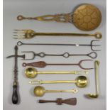 A Brass Fork, 19th Century, with four tines and a cut-out design of three hearts, 23ins, and a