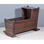 An Old Panelled Oak Crib with Rising Canopy and Tapered Sides on Rocker , 21ins x 36ins x 28ins