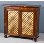 A Regency Figured Mahogany and Rosewood Dwarf Cabinet, with rounded moulded edge to top, bead mounts