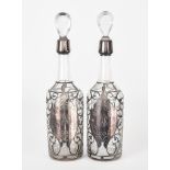 A Pair of Sterling Silver Mounted and Clear Glass Wine Bottles, stamped sterling D235, with shaped