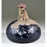 An Onion-Shaped Wine Bottle of Dark Tint, Early 18th Century, sealed, with barnacles to part of