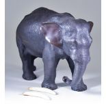 A Japanese Brown Patinated Bronze Standing Elephant, Meiji Period, with bone tusks, 6.75ins (17.