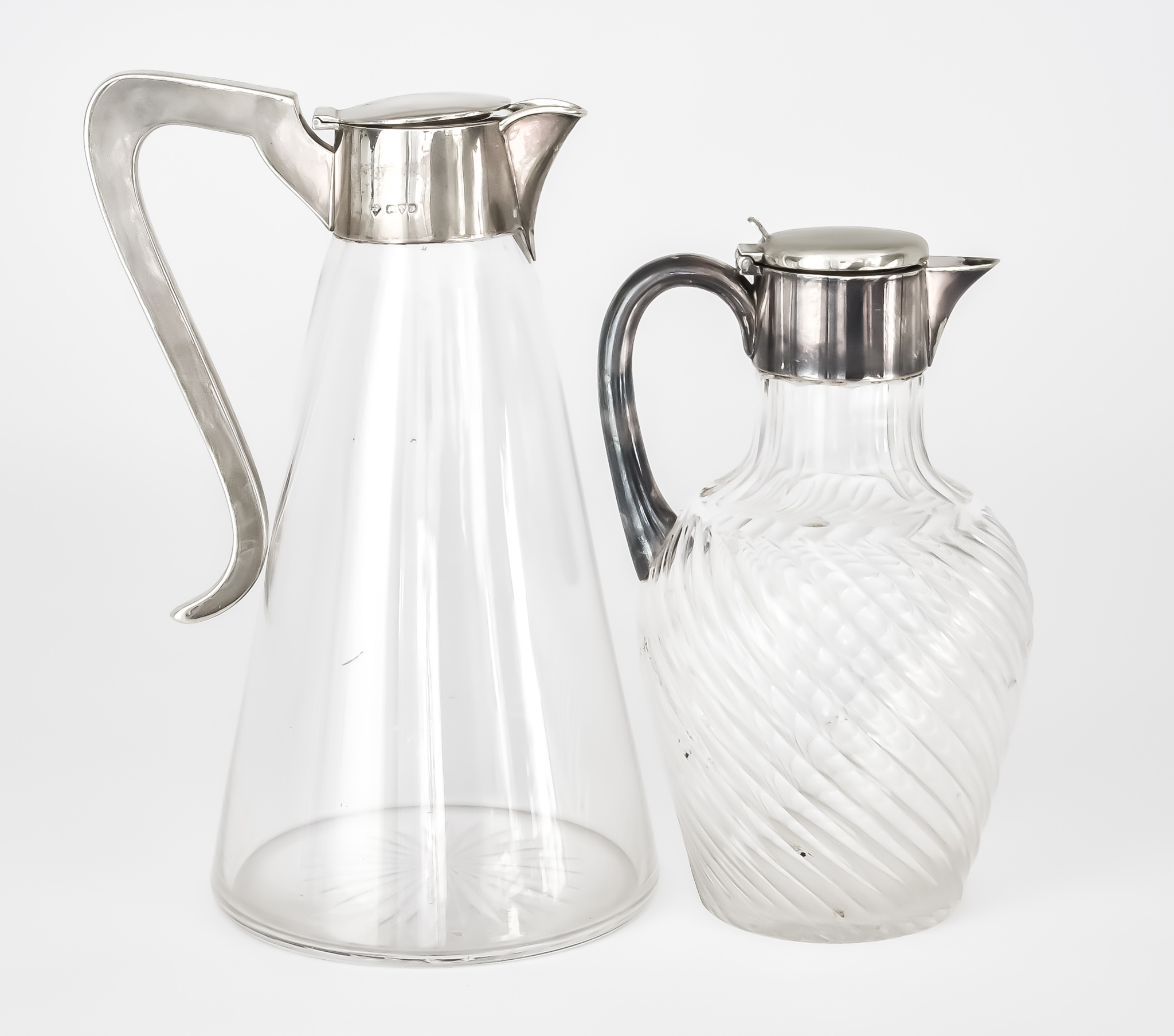 An Edward VII Silver Mounted and Clear Glass Claret Jug and a Plated Mounted and glass Claret Jug,