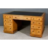 A Victorian Oak Partners Desk, with moulded edge and black leather inset to top, fitted three frieze