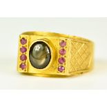 A 22ct Gold Ruby and Gem Stone Ring, Modern, set with a centre cabochon gem stone and eight small
