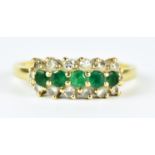 An Emerald and Diamond Ring, Modern, 18ct gold, set with five small emerald stones, approximately .