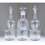 Seven Glass Finger Bowls, 19th Century, and Three Decanters, the finger bowls with slice cut bodies,