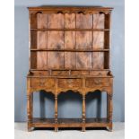 An Elm Dresser of 18th Century Design, the upper part with moulded cornice and shaped frieze