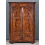 A George III Figured Mahogany Hanging Corner Cupboard, fitted three shelves and two small drawers,