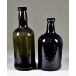 A Wine Bottle of Cylindrical Form of Olive Green Tint, Late 18th Century, with moulded string rim,