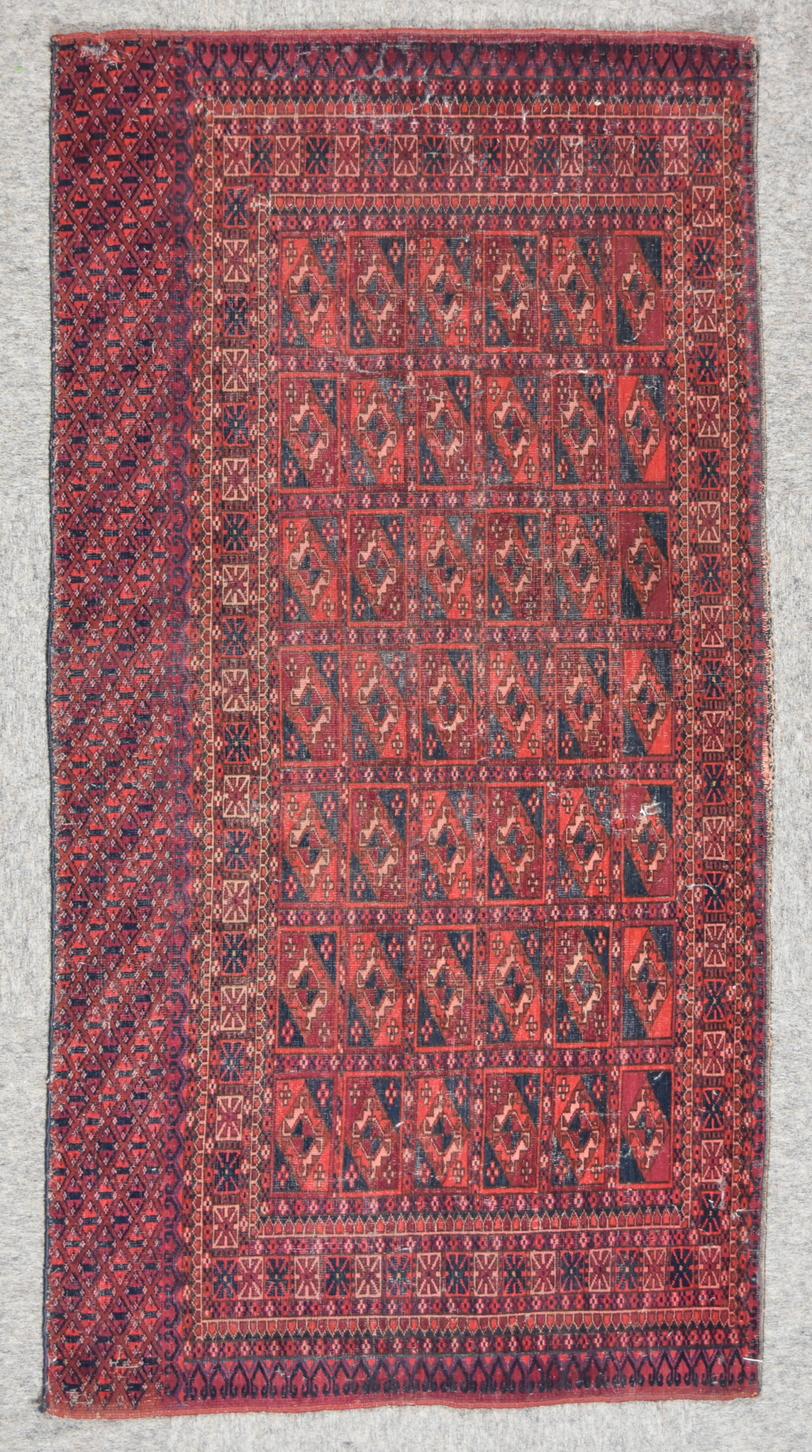 A Late 19th Century Tekke Turkmen Juval, woven in colours of ivory, navy blue and wine, the field