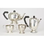 A George VI Harlequin Silver Circular Four Piece Tea Service, by A. Wilcox, Birmingham, 1945, and G.