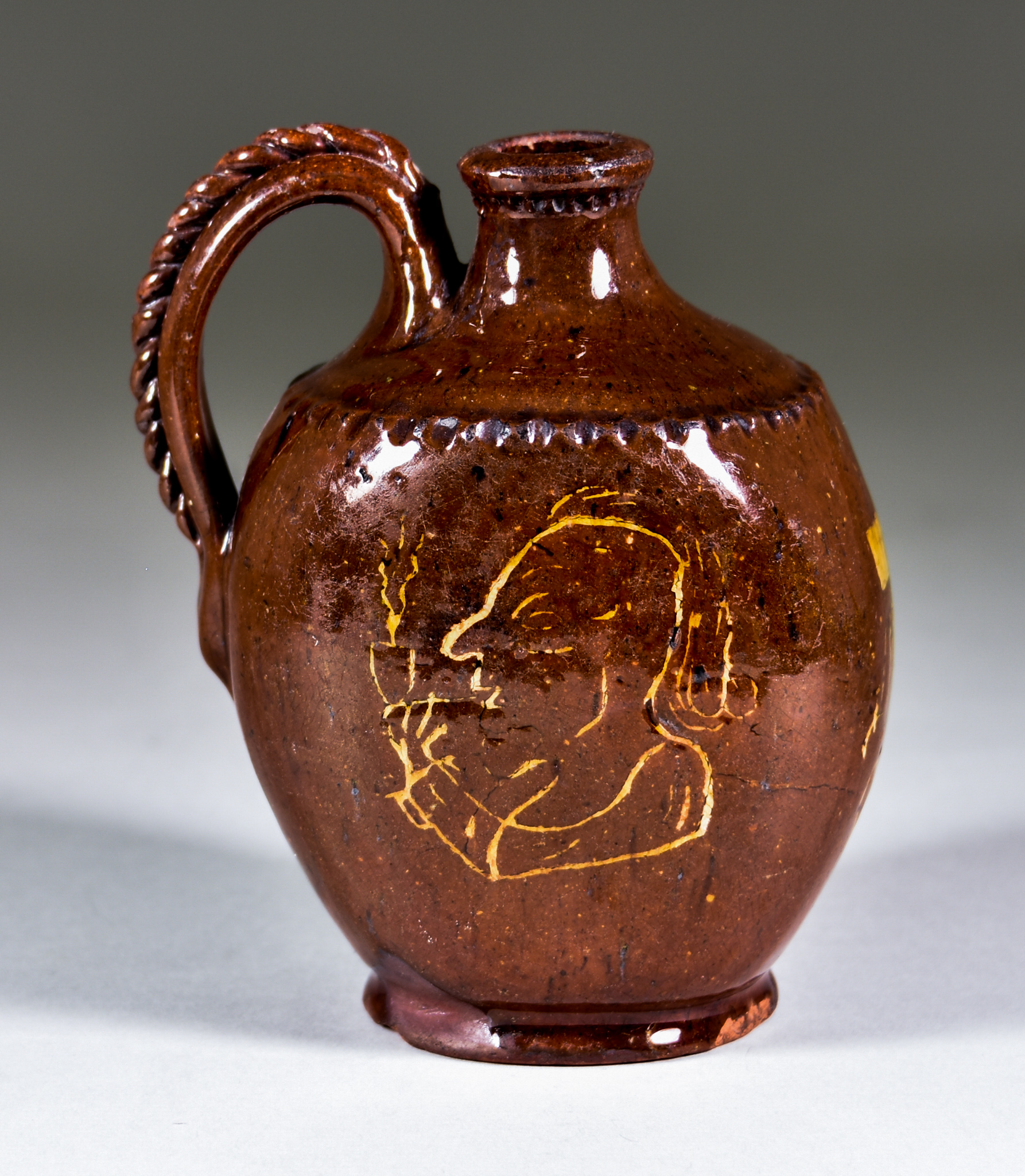 An English Lead Glazed Flask with Red Body, 19th Century, slip decorated with a man smoking a pipe