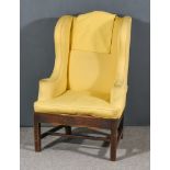 An Oak Framed Wing Back Easy Chair, with arched back upholstered in gold cloth on square front