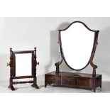 A George III Mahogany Shield-Shaped Toilet Mirror, on shaped uprights, the serpentine fronted base