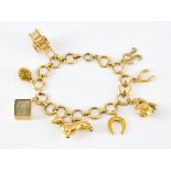 A 9ct Gold Charm Bracelet, 20th Century, with eight charms, various, 180mm, total gross weight 23.